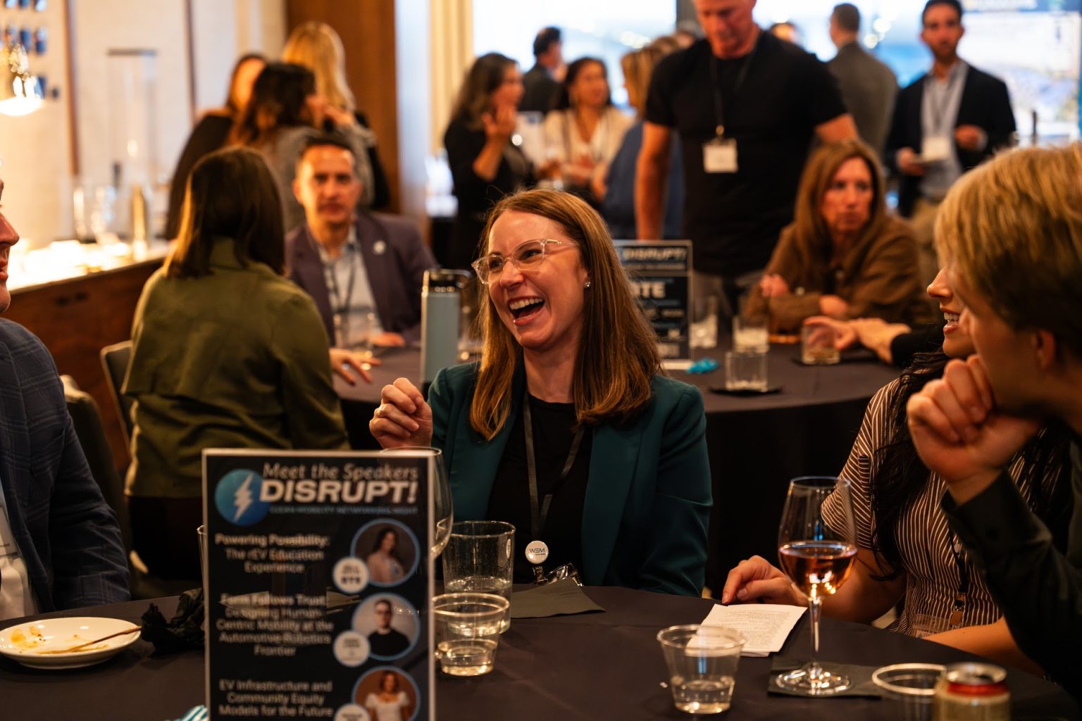 Attendees of DISRUPT! 2026 networking at tables